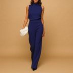 Sleeveless halter jumpsuit for women with high waist, wide legs, and decorative bow detail, perfect for summer dinners and evening occasions.