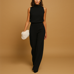 Sleeveless halter jumpsuit for women with high waist, wide legs, and decorative bow detail, perfect for summer dinners and evening occasions.